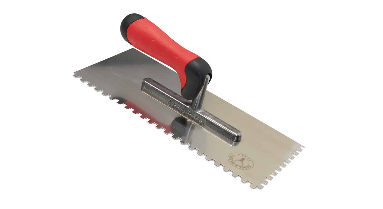 Regal & Barnes stainless steel notched trowel with a red and black soft-grip handle, designed for applying adhesive during external wall insulation installations.