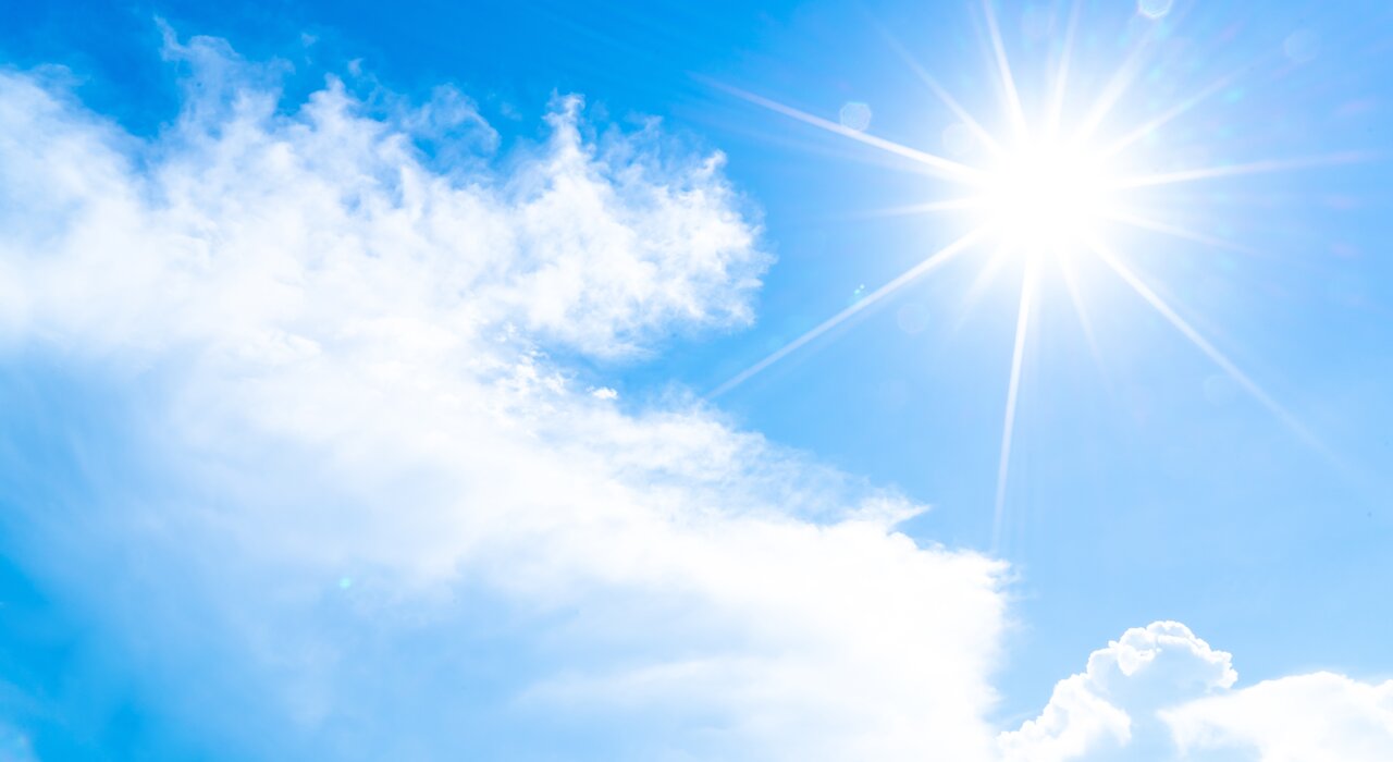 This image captures a bright, sunny sky with light clouds and strong sunlight—ideal for highlighting how external wall insulation can help keep buildings cool in hot weather by reflecting heat and improving thermal performance.