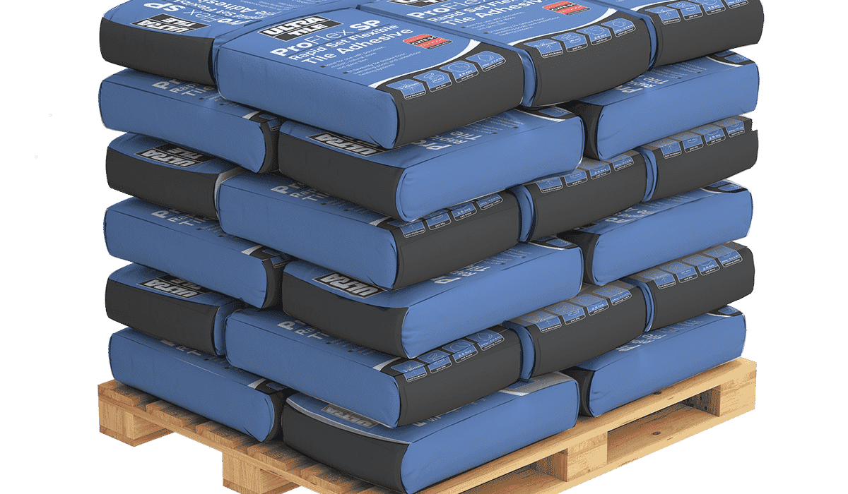 Pallet stacked with blue and black bags of adhesive used in external wall insulation systems. These adhesives are essential for securely bonding insulation boards to various surfaces, ensuring long-lasting thermal protection and structural stability.