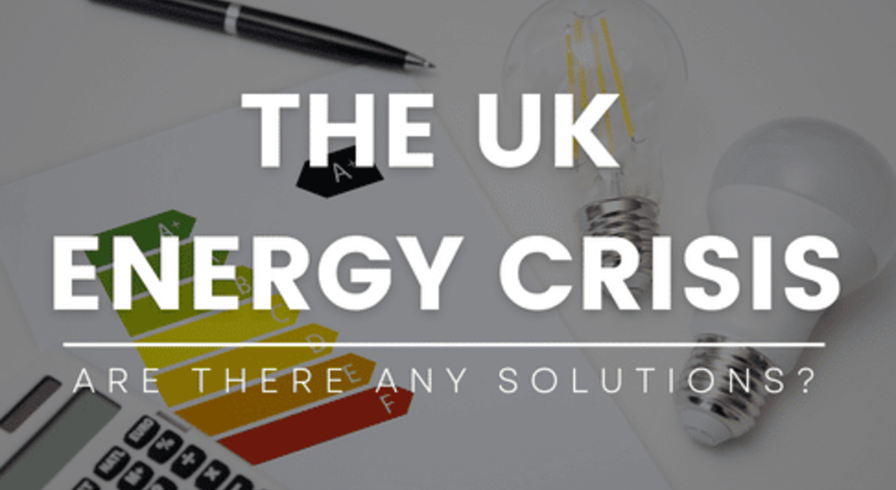 graphic with the title "The UK Energy Crisis – Are There Any Solutions?" overlaid on an image of light bulbs, energy efficiency chart, calculator and pen, promoting EWI Store as a render specialist offering insulation solutions for improved energy performance