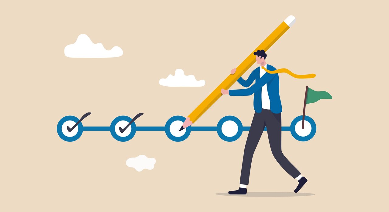 A man checks off a project plan using a giant pencil, representing the importance of following each retrofit step correctly for successful energy improvements.