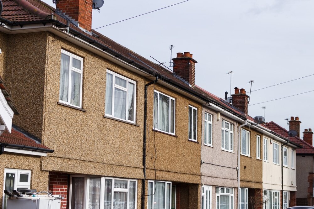 A row of rendered houses, common in the UK. Many of these benefit from retrofitting external wall insulation to improve warmth and cut heating costs.