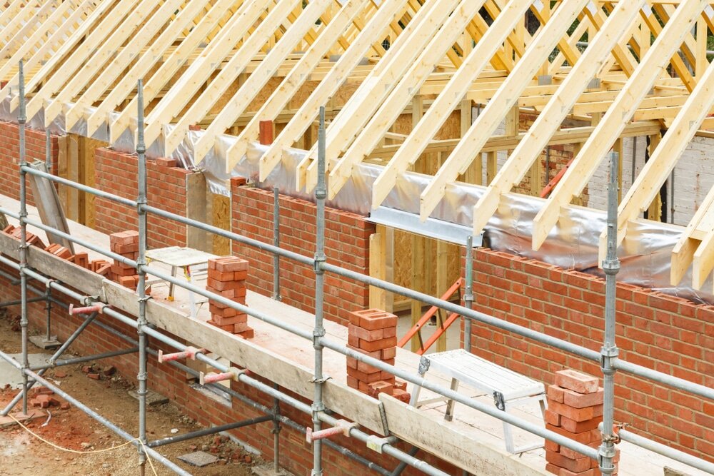 A traditional brick house under construction. Once completed, external wall insulation can be added to meet modern energy standards.