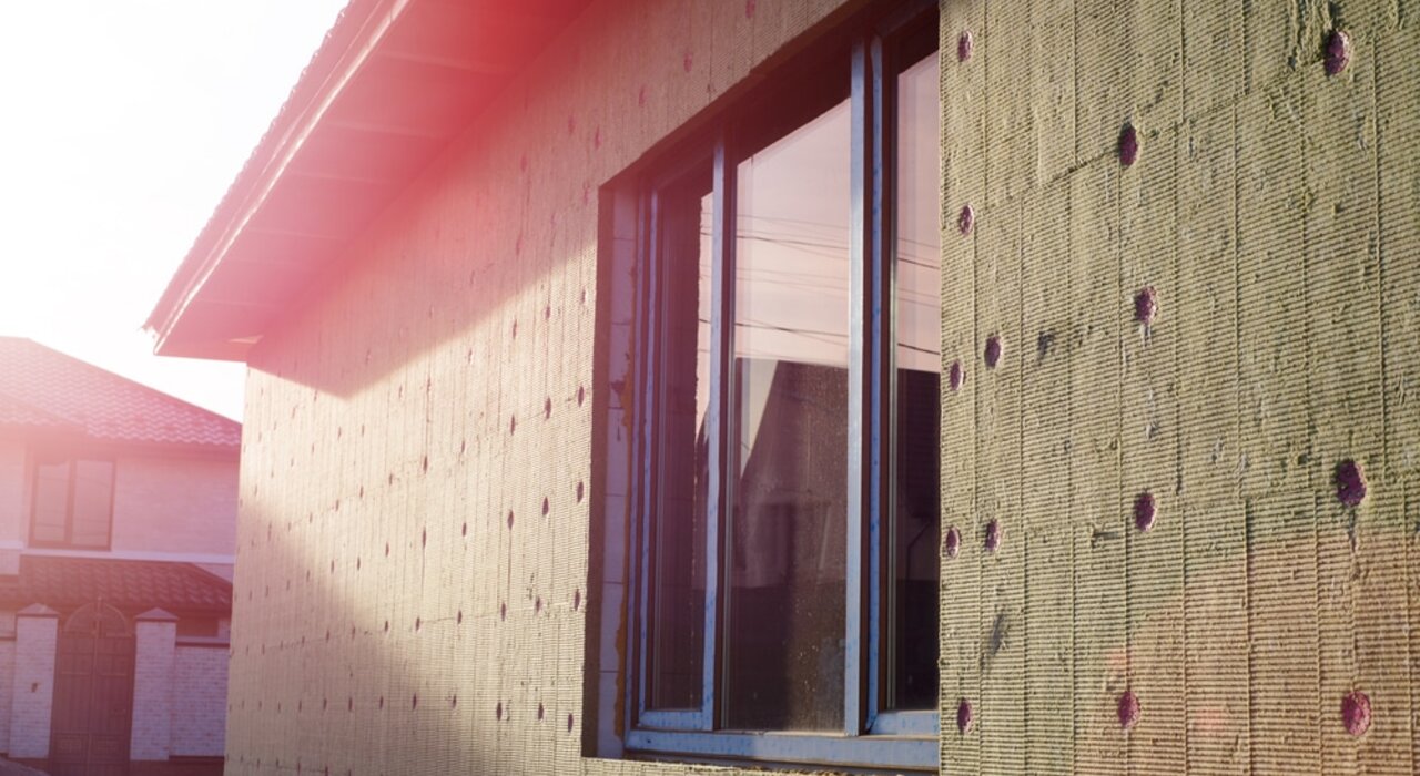 Close-up of a residential property fitted with mineral wool insulation boards. The boards are securely fixed in preparation for the basecoat layer. Available from EWI Store, Rockwool insulation offers excellent fire resistance, soundproofing, and thermal performance.