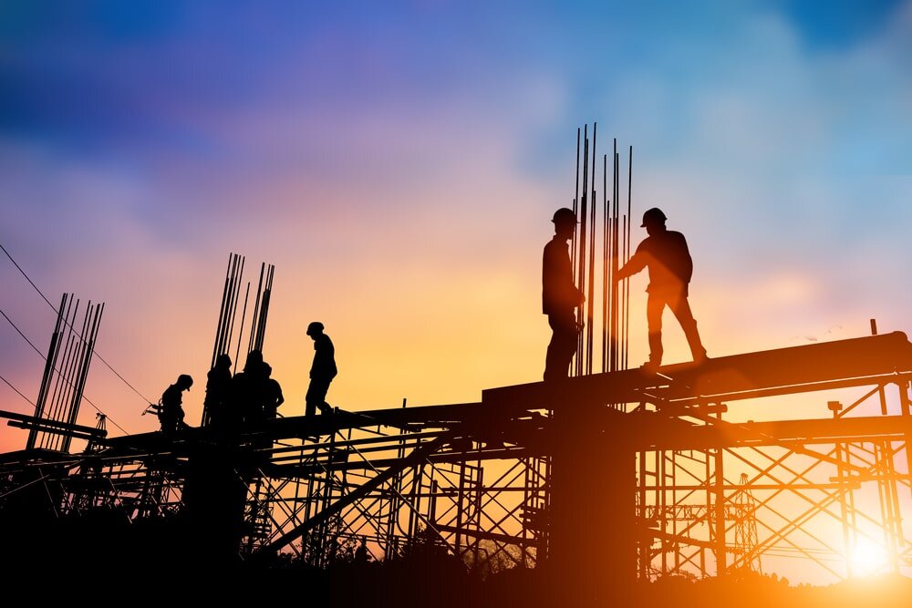 Silhouette of workers standing on scaffolding during a sunset. At EWI Store, we support professionals working in all conditions with reliable insulation and render systems that deliver long-lasting performance and thermal efficiency—rain or shine, day or night.