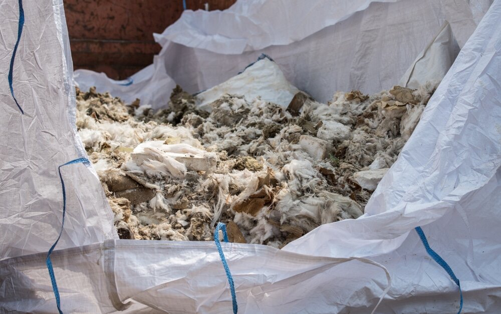Bag filled with old mineral wool insulation. Proper removal is the first step toward energy-efficient upgrades. EWI Store supplies high-performance insulation materials designed to replace outdated, inefficient loft insulation—helping homeowners meet modern energy standards.