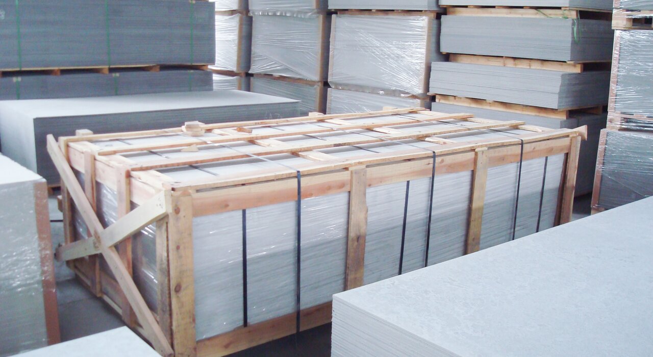 Pallet of cement boards stacked and strapped for transport. These fibre cement boards, available from EWI Store, are used as durable substrates for render systems in both residential and commercial applications.