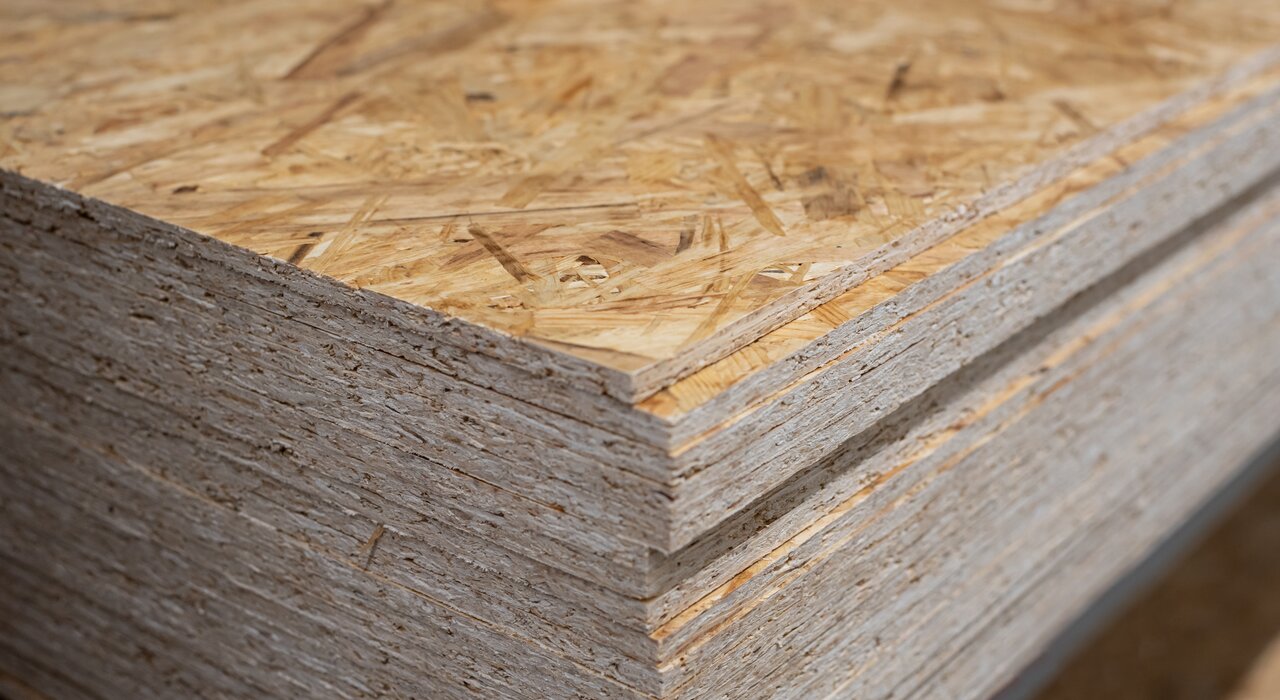 Stack of oriented strand board (OSB) sheets used for sheathing or as part of a render carrier board system. OSB from EWI Store provides a stable base layer in timber frame and retrofit installations.