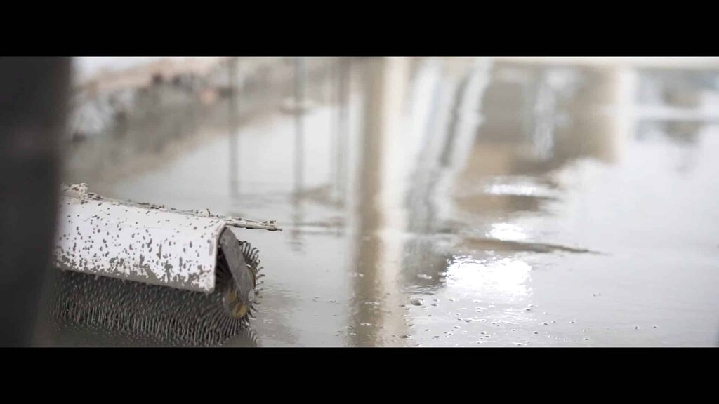 view of a spiked roller on a freshly applied self-levelling floor compound. EWI Store provides all essential floor levelling accessories to support high-quality, even finishes in any renovation project.