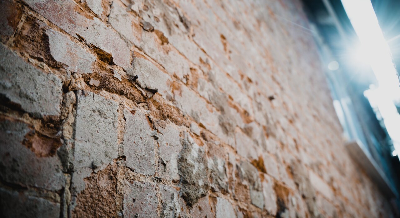Exposed brickwork after render removal, ready for inspection and preparation. EWI Store stocks render removal tools and primers to help professionals start fresh with a durable EWI Pro render system.