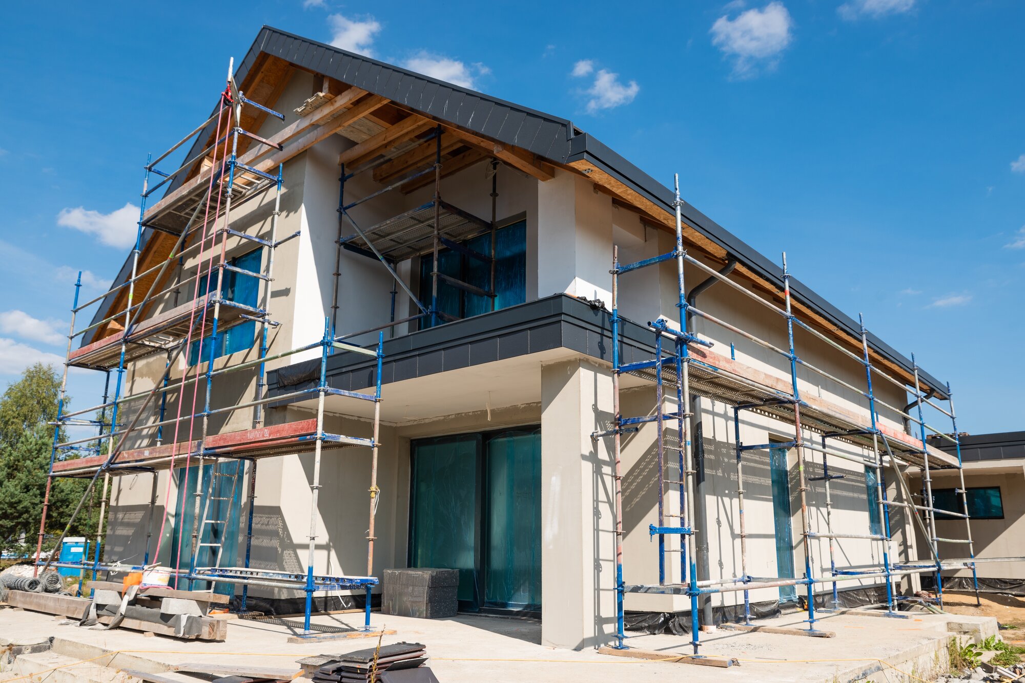 large home with scaffolding and external wall insulation