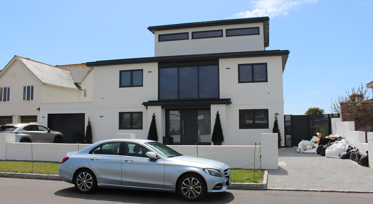 Front view of a modern detached property finished in a crisp white render. External wall insulation paired with high-performance render from EWI Store enhances kerb appeal while improving thermal performance. EWI Store supplies all materials needed for premium, energy-efficient façade upgrades.