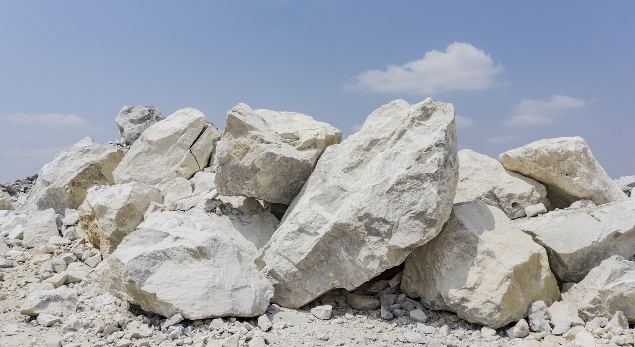 Close-up of a pile of natural limestone rocks, a key raw material used in the production of lime-based EWI Pro adhesives and renders. At EWI Store, we prioritise quality from the source, ensuring our lime-based products deliver strength, breathability, and superior adhesion for external wall insulation systems.