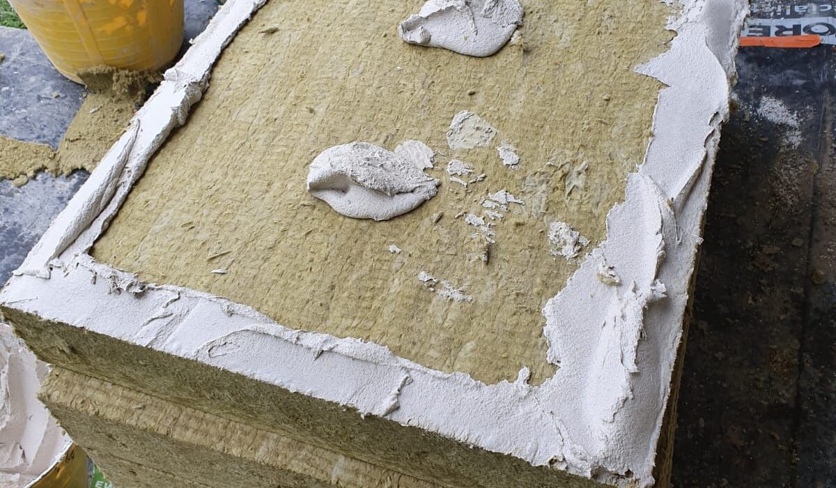 Prepared slab of Rockwool Dual Density mineral wool insulation with EWI Pro Premium Basecoat applied using the perimeter and dab method. This non-combustible insulation board, available at EWI Store, provides outstanding thermal and acoustic performance, making it ideal for use in high-performance EWI systems.