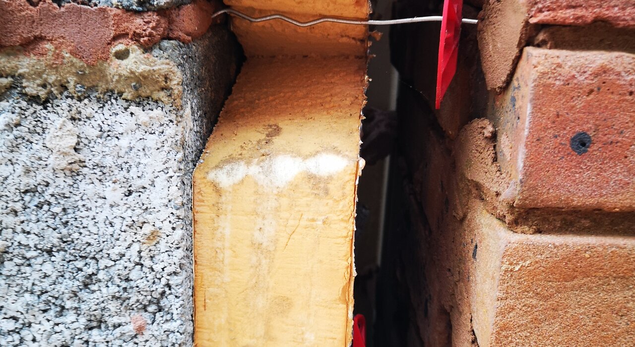 Cross-section of a cavity wall with PIR insulation and wall ties in place. The high-performance rigid insulation board helps to reduce heat loss while maintaining structural integrity. Available through EWI Store, our PIR boards are ideal for cavity wall upgrades and energy efficiency improvements.