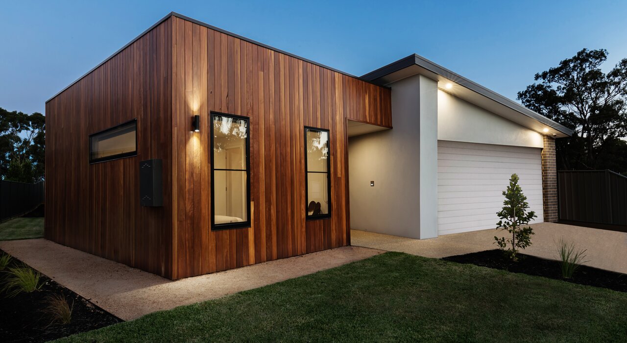 Contemporary home with timber cladding and smooth white render façade. This modern aesthetic demonstrates the versatility of EWI Pro renders, which combine durability with a premium finish. EWI Store provides all materials needed for creating thermally efficient, visually striking façades.