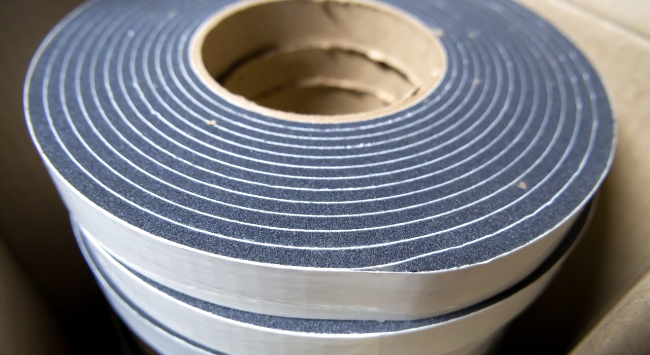 Close-up of a roll of expanding foam tape, ideal for sealing window and door frames. Available from EWI Store, this compressible sealing solution provides excellent airtightness and weatherproofing, helping improve thermal efficiency and reduce unwanted drafts in external wall insulation systems.
