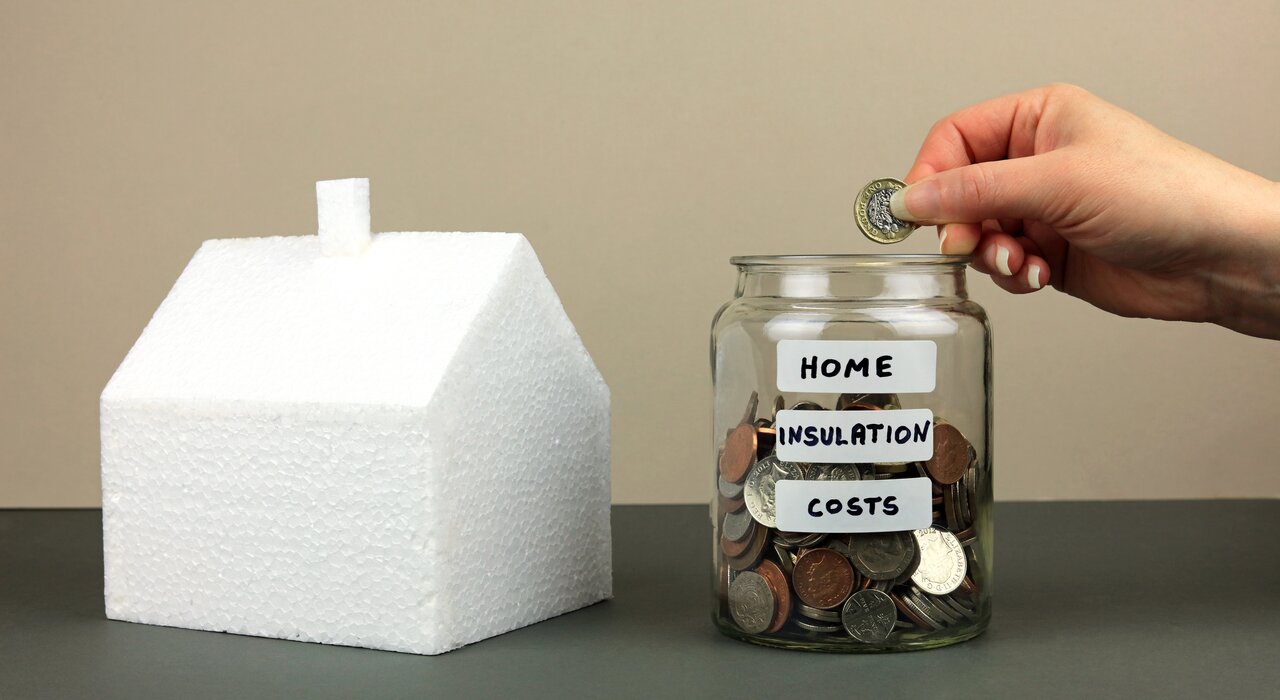 Conceptual image showing a model house made from polystyrene and a jar labeled “Home Insulation Costs.” Highlighting the energy-saving potential of EWI Store insulation systems, this image reflects how proper insulation reduces energy bills and improves long-term home efficiency.