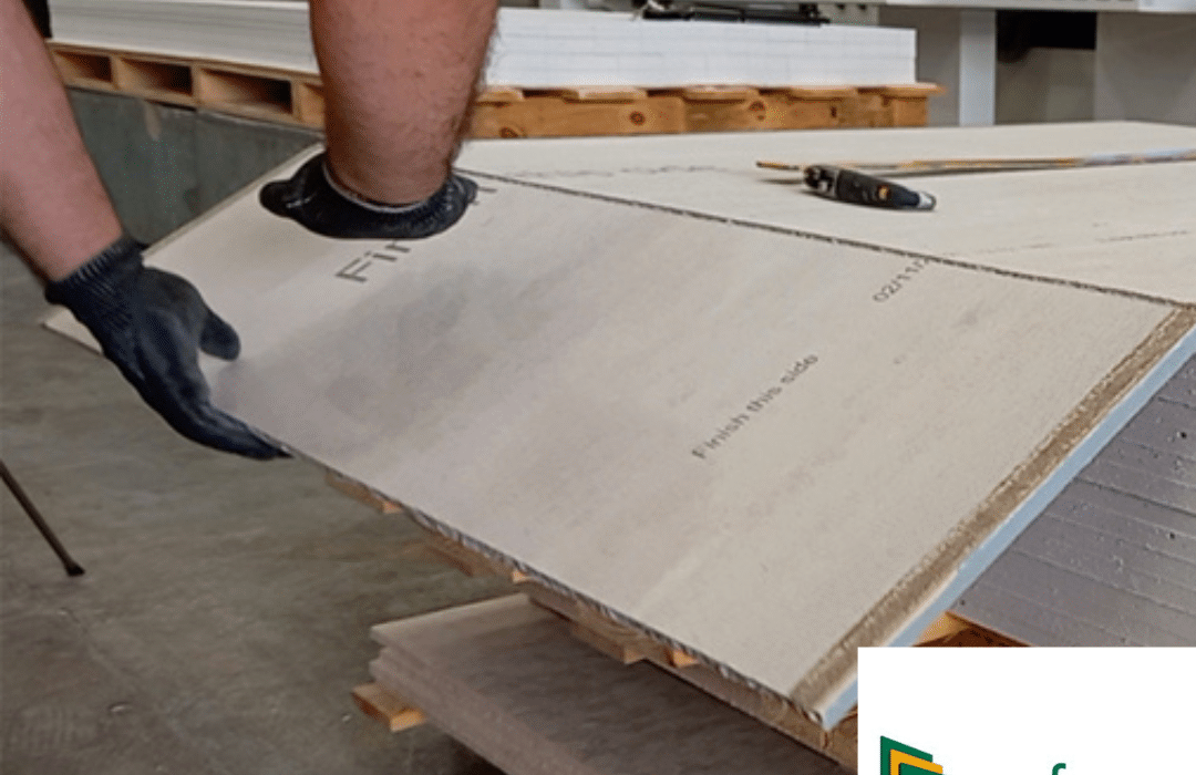 Close-up of hands holding a cement board during processing. Cement boards like this are moisture-resistant, non-combustible, and dimensionally stable, making them ideal as a substrate in EWI systems. Available at EWI Store, they provide a reliable base layer for render and insulation applications.