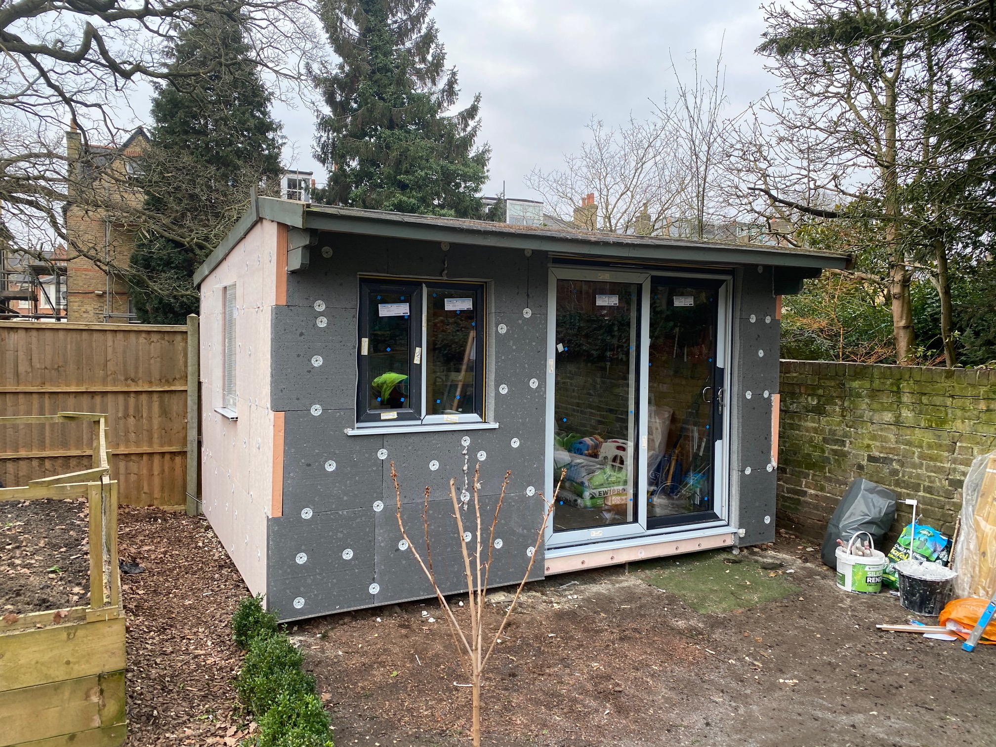 Garden shed with external insulation and awaiting render